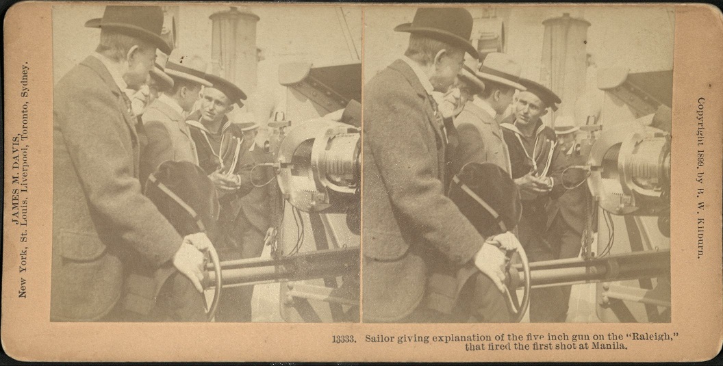 Sailor giving explanation of the five inch gun on the “Raleigh,” that fired the first shot at Manila.